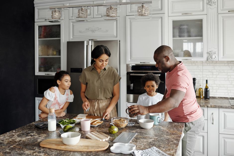 A family enjoys preparing a meal together in their modern kitchen, fostering warmth and togetherness.