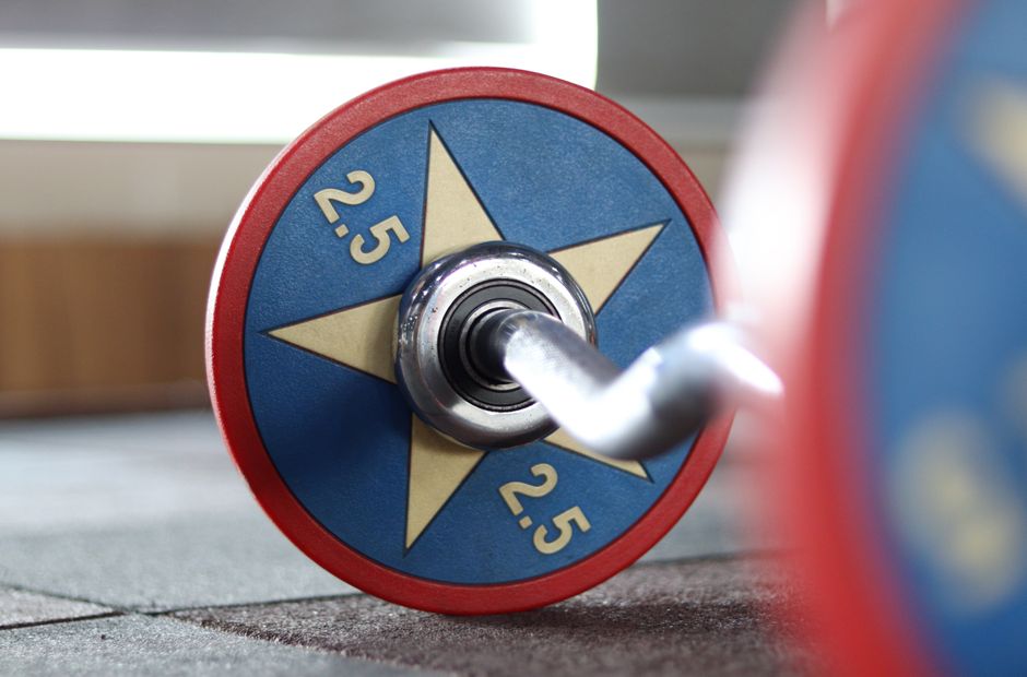 A vibrant 2.5 kg barbell with star design captured in a gym setting, perfect for fitness themes.