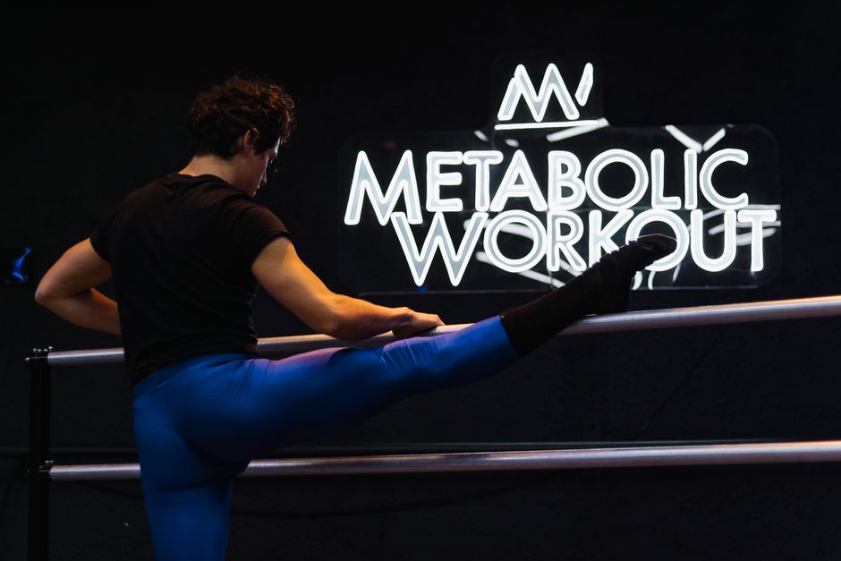 Athlete performing a leg stretch at Metabolic Workout studio in Mexico City.
