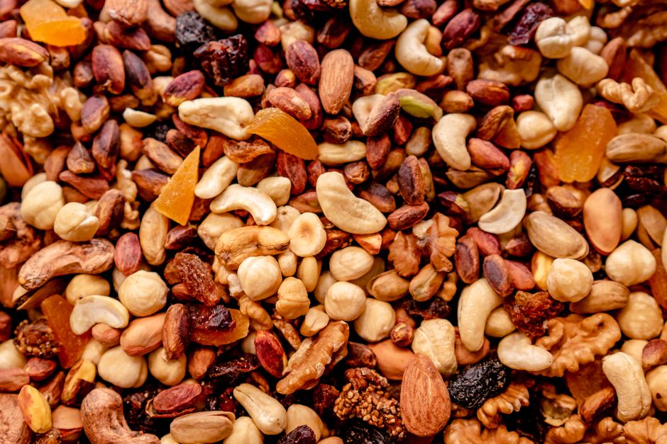 Close-up of assorted nuts and dried fruits creating a colorful, nutritious mix.