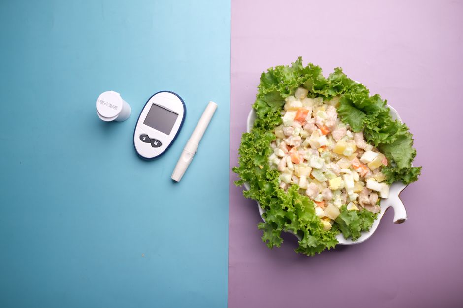Top view of diabetes equipment and fresh salad representing healthy living.