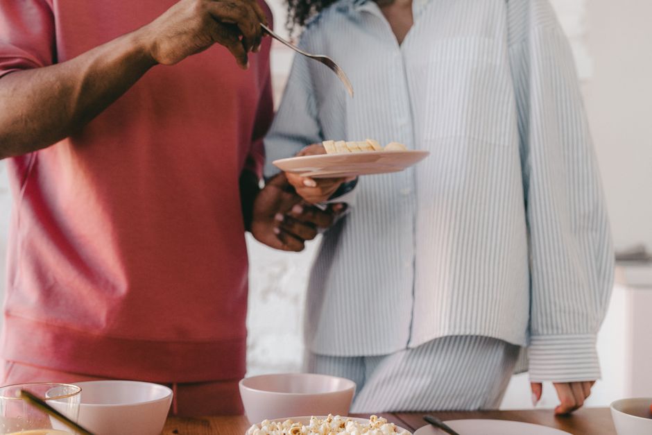 A couple in modern pajamas enjoys a healthy breakfast together indoors.