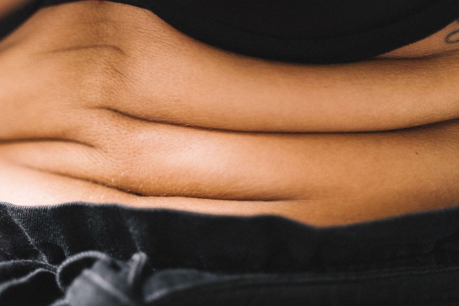 A detailed close-up image showcasing the natural creases and texture of human skin on the belly.