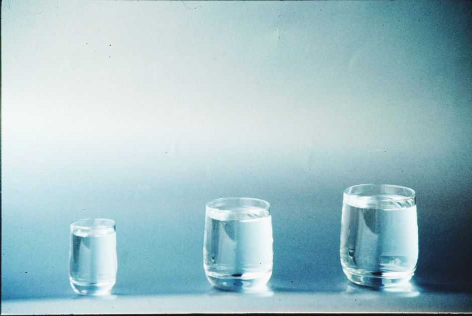 A minimalist image showcasing three different-sized glasses filled with water.