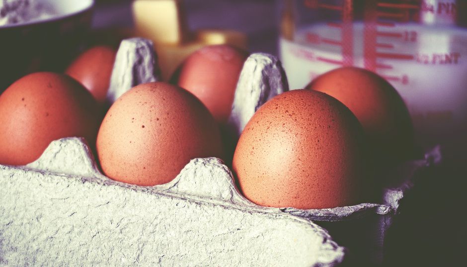 Brown eggs in a carton, shot in a soft light, perfect for breakfast or bakery themes.