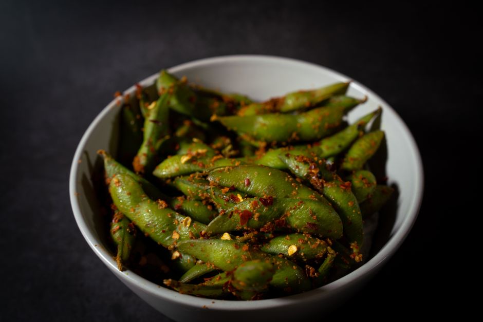Close-up of spicy edamame beans in a bowl, showcasing vibrant flavors and textures.