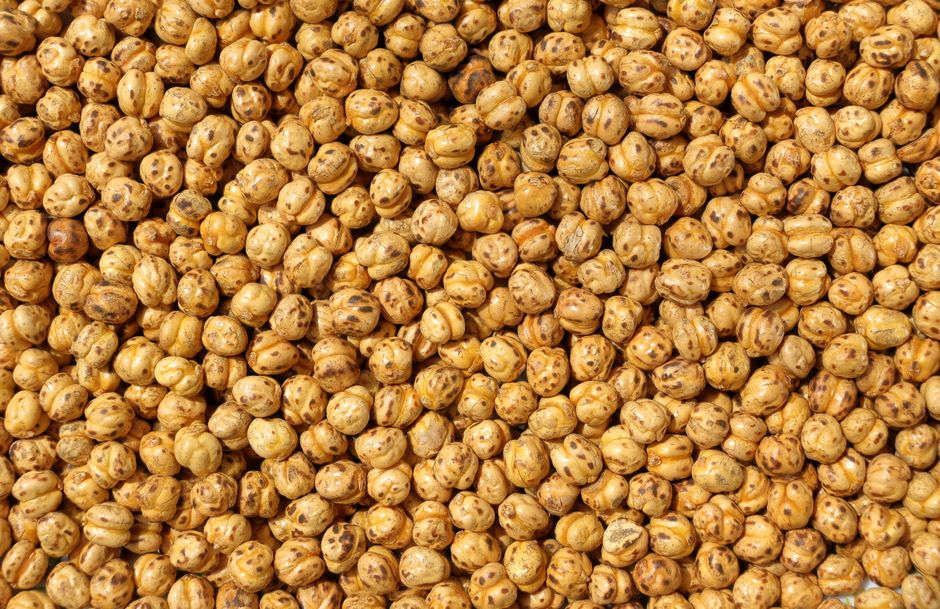 Close-up texture of roasted chickpeas providing a healthy snack background.