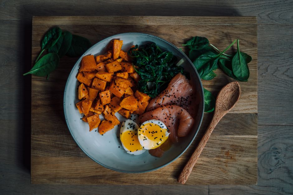 Delicious and nutritious meal featuring salmon, sweet potato, and eggs, perfect for a healthy diet.