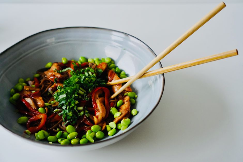 Explore this vibrant chicken noodle bowl with fresh vegetables, perfect for a healthy meal.