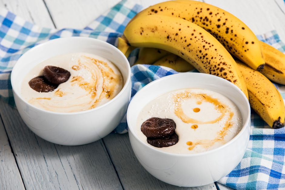 Healthy breakfast yogurt with bananas and figs, drizzled with syrup, perfect for a sweet start.