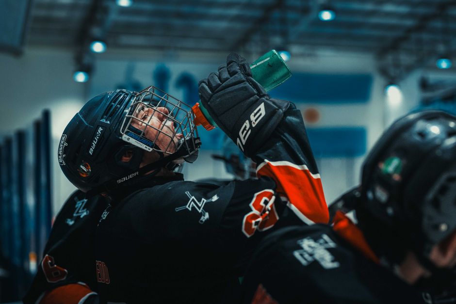 Ice hockey player in action drinking water during a game break in Buenos Aires.