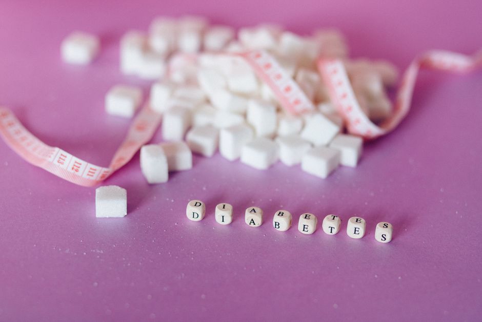 Still life of sugar cubes and diabetes concept with a tape measure, highlighting health awareness.