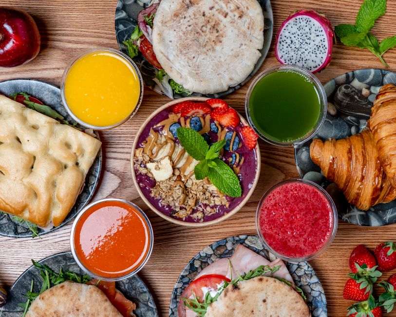 Vibrant breakfast spread featuring smoothies, pastries, and fresh fruits. Perfect for a healthy start.