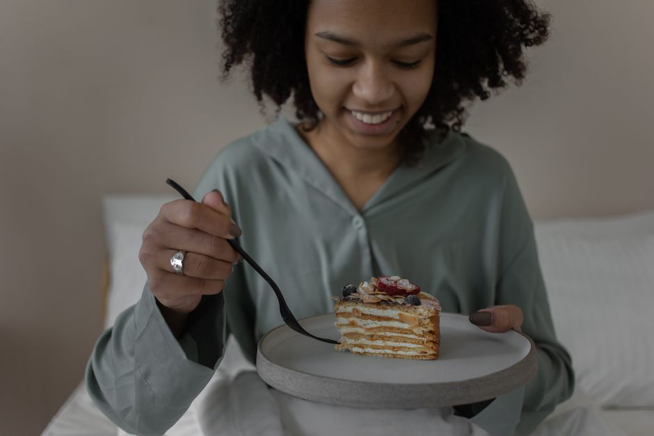 A joyful morning with a woman enjoying breakfast in bed. Relaxing start to the day.