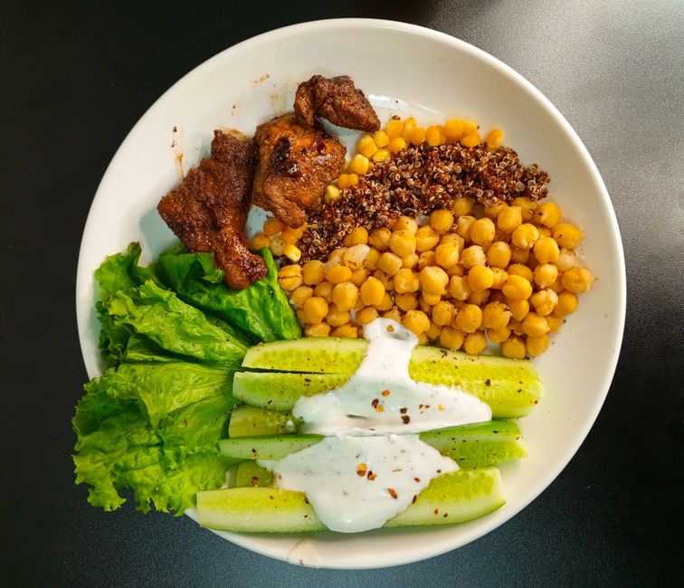 A nutritious bowl with quinoa, chickpeas, and fresh vegetables, perfect for a healthy meal.