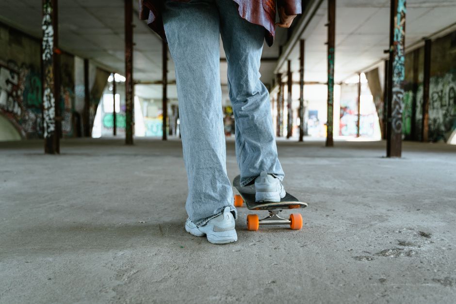 A skateboarder glides through an urban graffiti-covered skate park, showcasing skill and style.