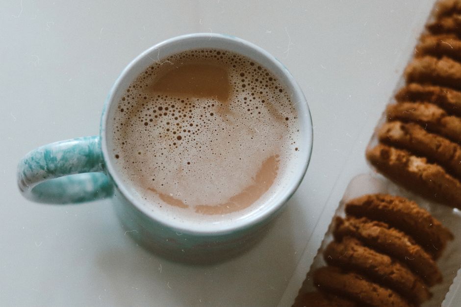 A warm cup of coffee paired with delicious biscuits, perfect for a cozy atmosphere.