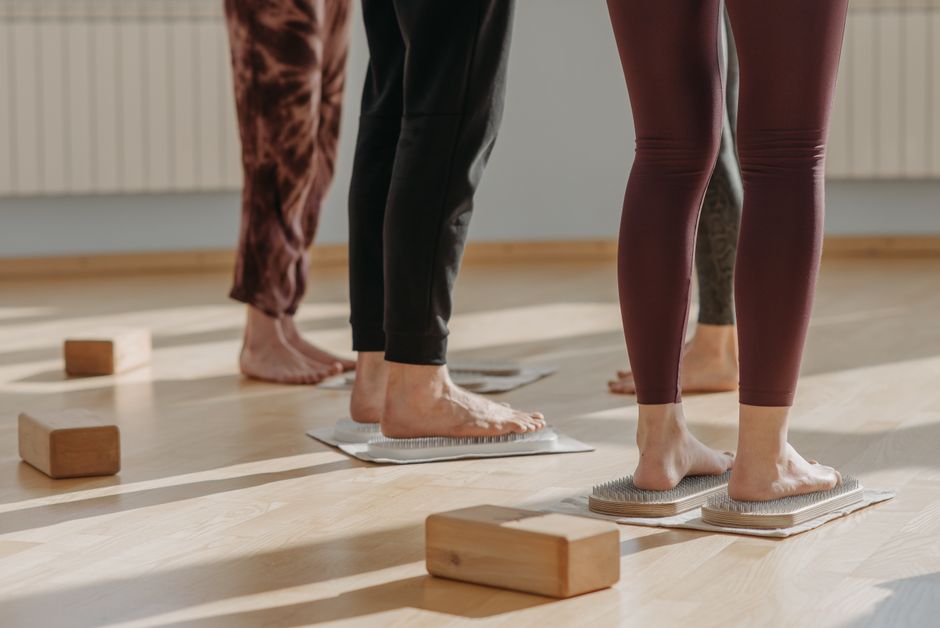 Close-up of feet during a yoga class focusing on balance and posture indoors.