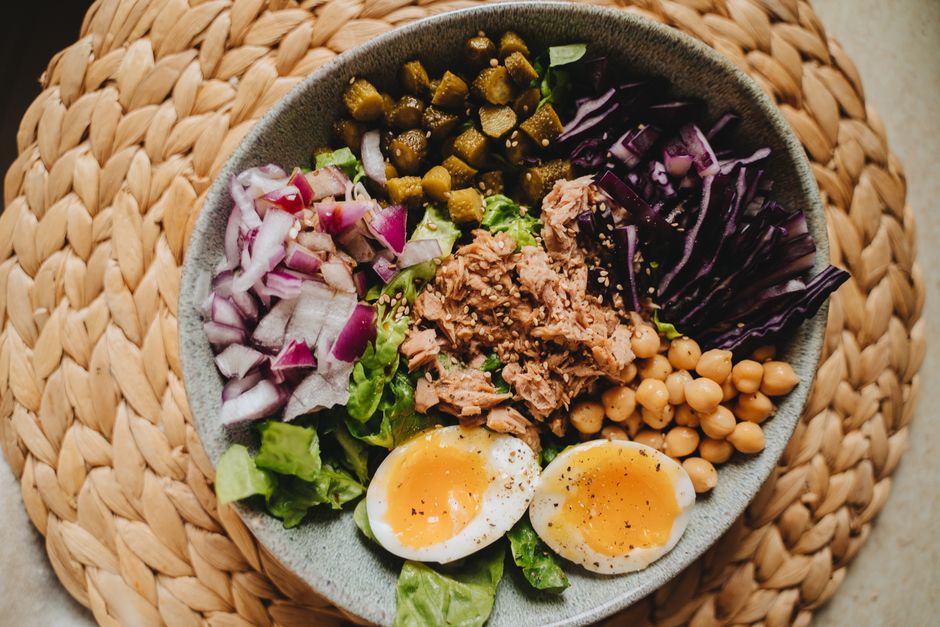 Delicious salad bowl with tuna, eggs, and fresh vegetables, perfect for a nutritious meal.