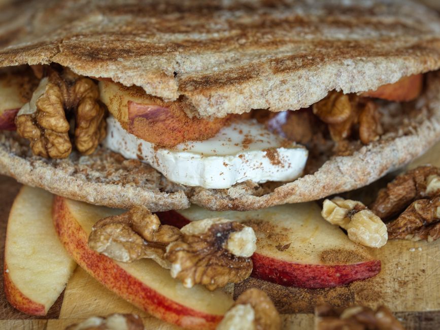 Delicious whole grain pita filled with brie cheese, apple slices, walnuts, and cinnamon.
