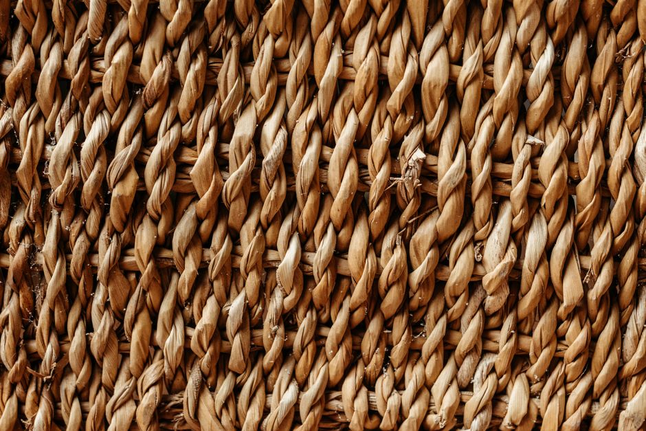 Detailed close-up of a textured woven straw surface showcasing natural patterns.