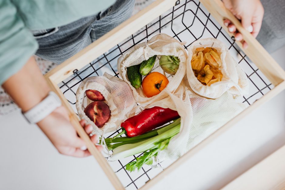 Top view of fresh produce in reusable bags, promoting sustainable shopping and zero waste.