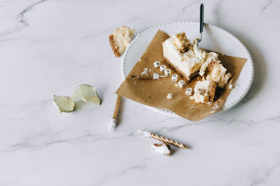 A half-eaten cake with the word 'burnout' on a plate, symbolizing stress and fatigue.