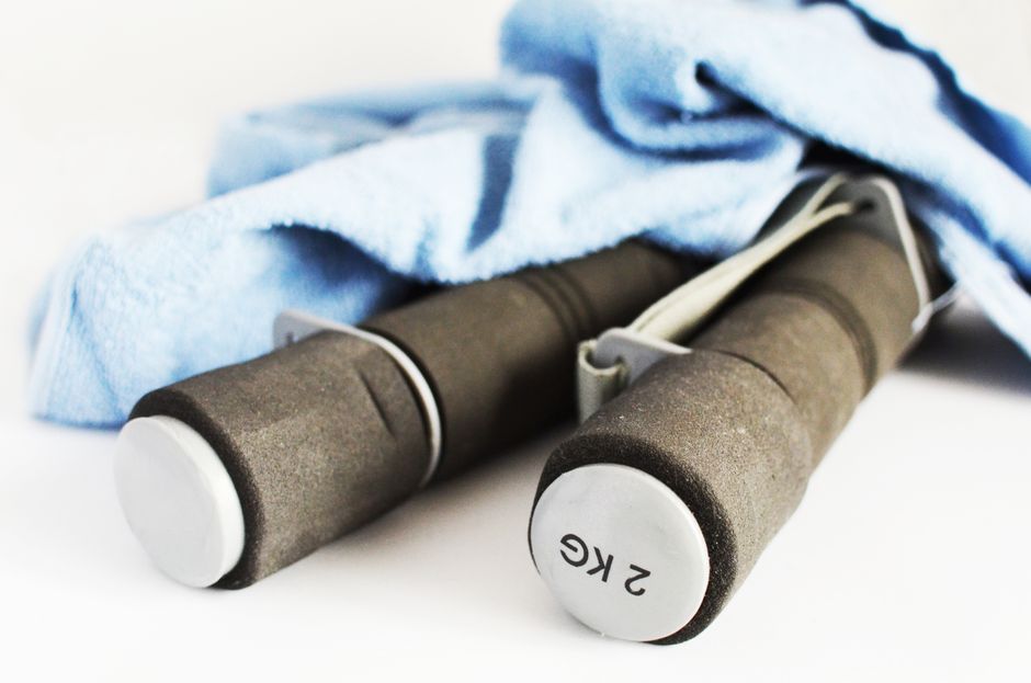 Close-up of 2kg dumbbells and a towel, perfect for a fitness routine or gym workout.