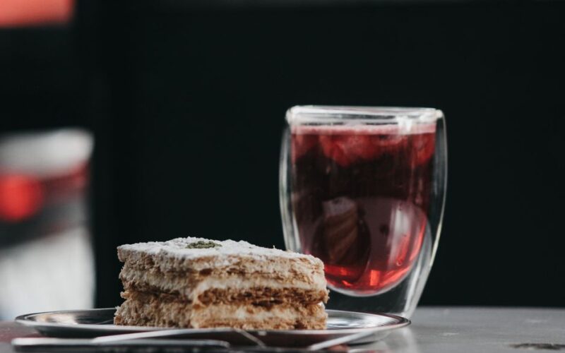 Delicious layered pastry served with a chilled beverage in a glass, perfect for a refreshing treat.