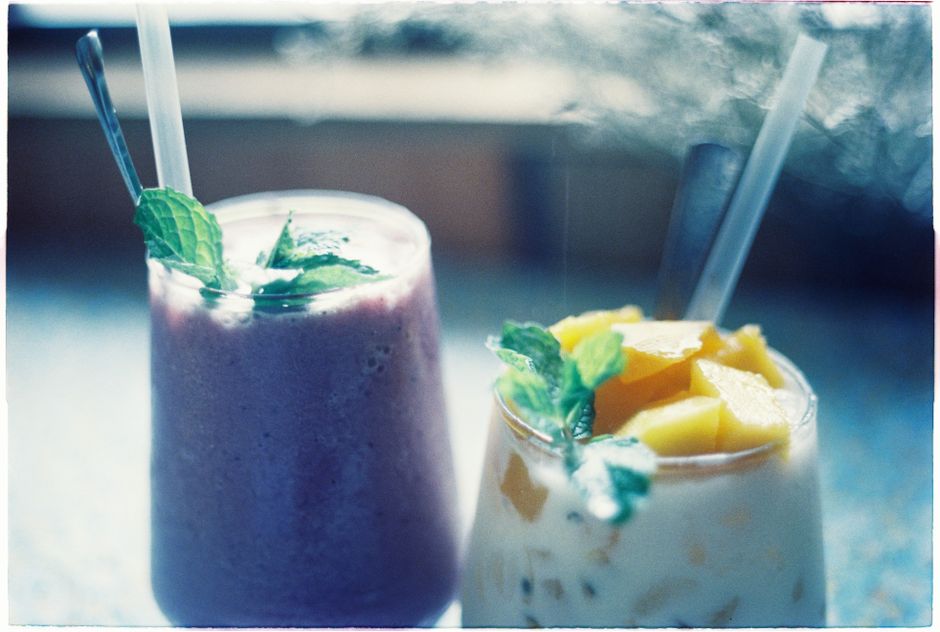 Refreshing tropical fruit smoothies topped with fresh mint, perfect for a summer treat.
